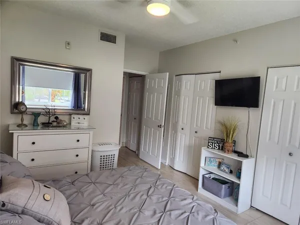 a room with a bed and a flat screen tv