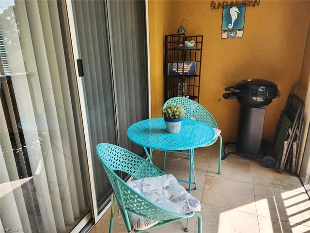 a view of a room with a table and chairs
