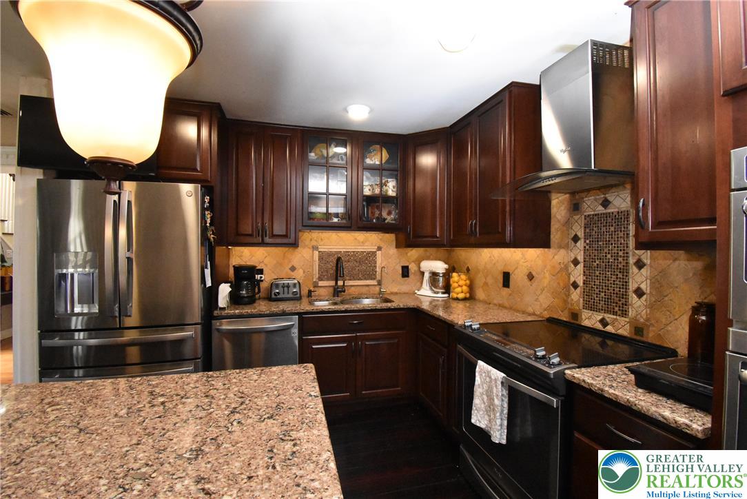 424 Grape Street Whitehall, PA 18052 - Photo 25 of 56 This spacious kitchen offers ample counter space and storage, perfect for culinary endeavors.