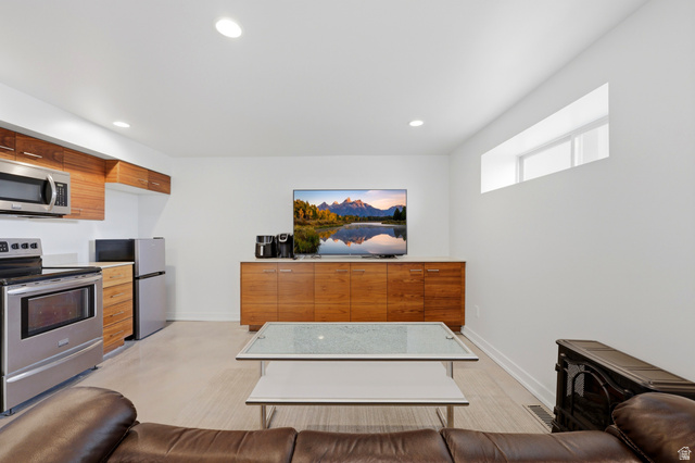 1389 Millbrook Way Bountiful, UT 84010 - Photo 45 of 74 Compact living area featuring an integrated kitchen with stainless steel appliances, wood-finish cabinetry, and a light countertop