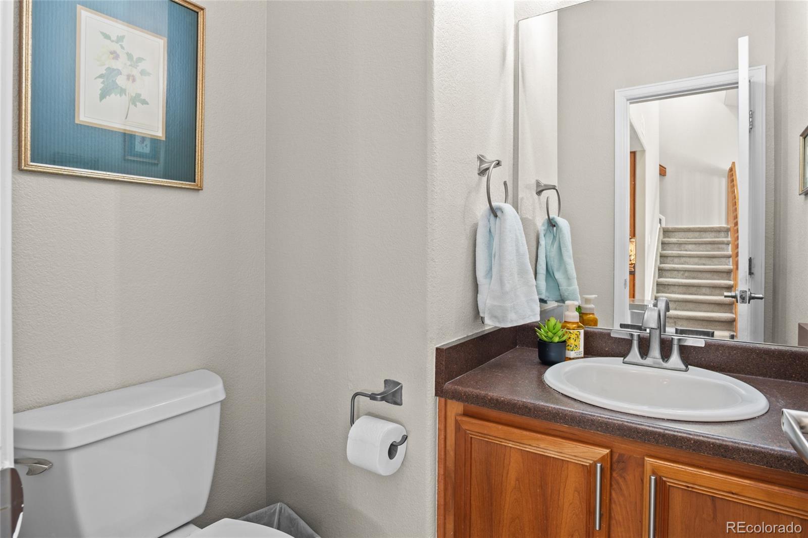 10550 Paris Street, Unit 705 Henderson, CO 80640 - Photo 11 of 30 a bathroom with a granite countertop sink toilet and mirror