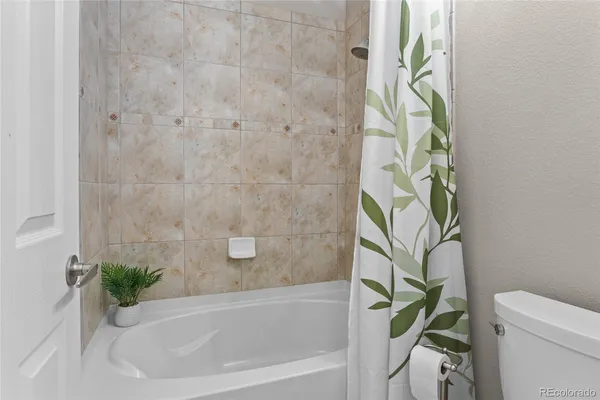 a bathroom with a bathtub and shower
