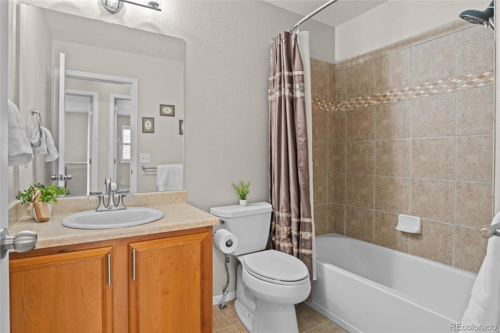 10550 Paris Street, Unit 705 Henderson, CO 80640 - Photo 18 of 30 a bathroom with a granite countertop sink toilet and shower