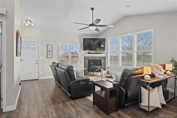 a living room with furniture a fireplace and a flat screen tv