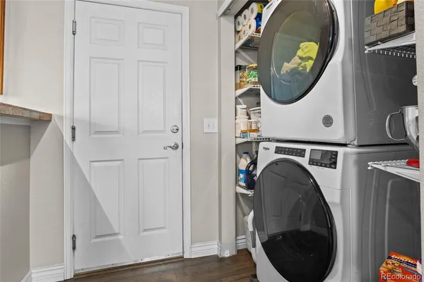 an entryway with sitting space and a wooden floor