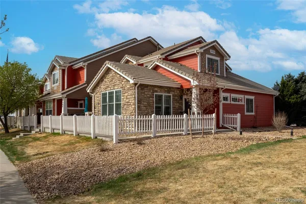 a front view of a house with a yard outdoor seating and garage
