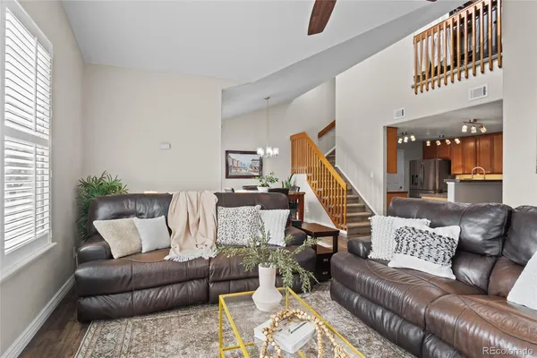 a living room with furniture and a wooden floor