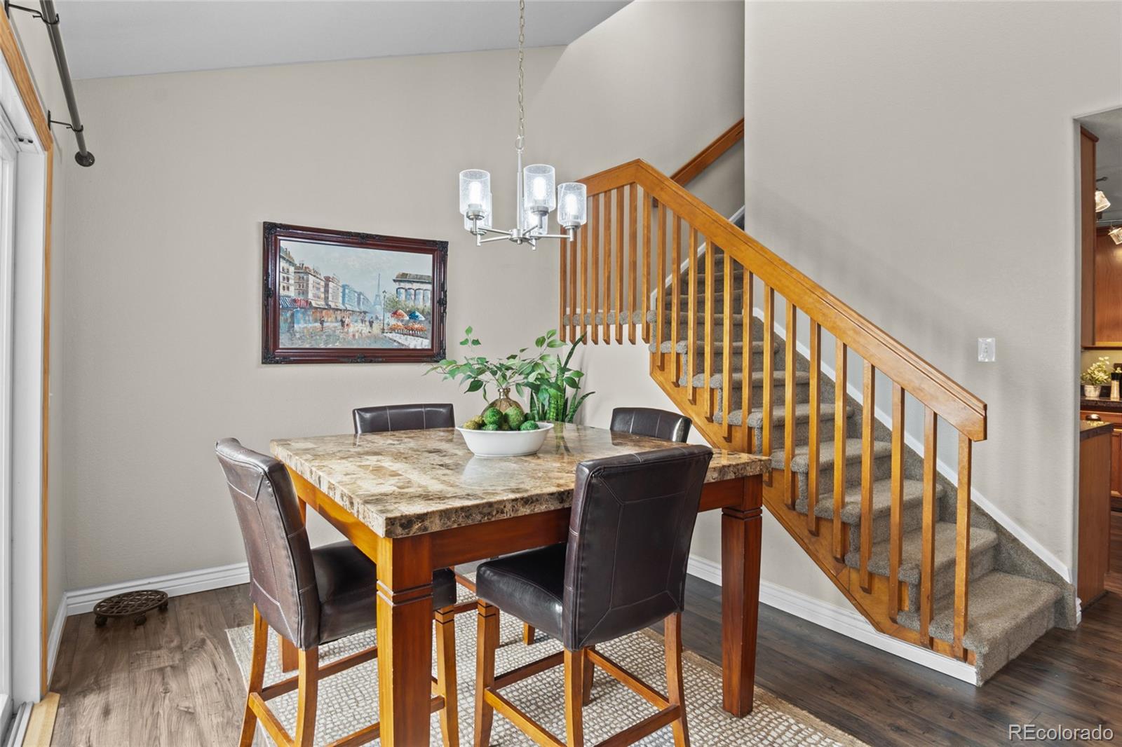 10550 Paris Street, Unit 705 Henderson, CO 80640 - Photo 7 of 30 a view of a dining room with furniture and wooden floor