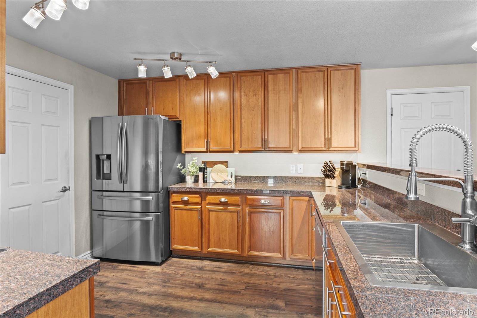 10550 Paris Street, Unit 705 Henderson, CO 80640 - Photo 8 of 30 a kitchen with granite countertop a refrigerator and a sink