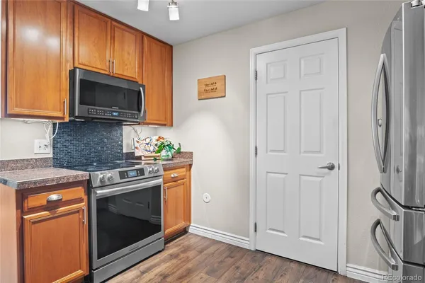 a kitchen with stainless steel appliances wooden cabinets and a stove top oven