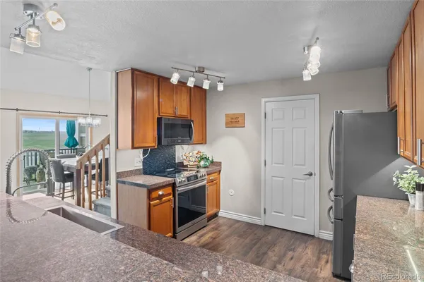 a kitchen with stainless steel appliances granite countertop a stove and a refrigerator