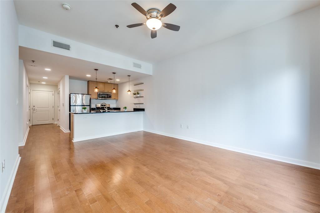 1200 Main Street, Unit 1908 Dallas, TX 75202 - Photo 3 of 27 a view of a kitchen with a sink and a chandelier fan