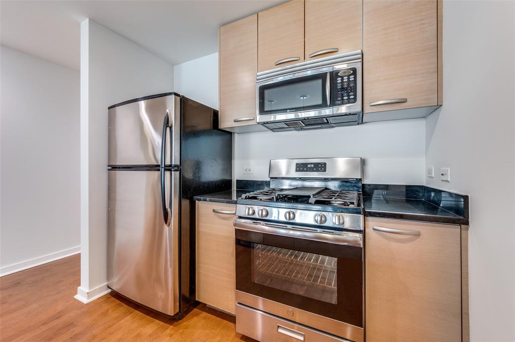 1200 Main Street, Unit 1908 Dallas, TX 75202 - Photo 6 of 27 a kitchen with a stove and a microwave