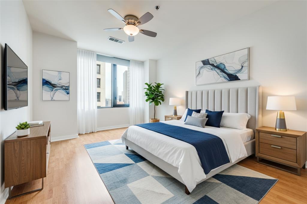 1200 Main Street, Unit 1908 Dallas, TX 75202 - Photo 10 of 27 a bedroom with a large bed and a chandelier