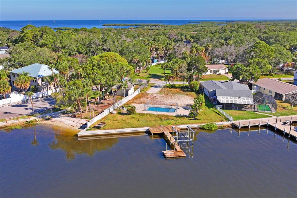 5224 Miller Bayou Drive Port Richey, FL 34668 - Photo 6 of 24 a view of a swimming pool with lawn chairs