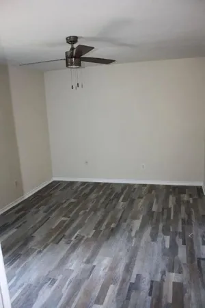 a view of a room with wooden floor