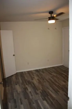a bathroom with a granite countertop white toilet and a shower