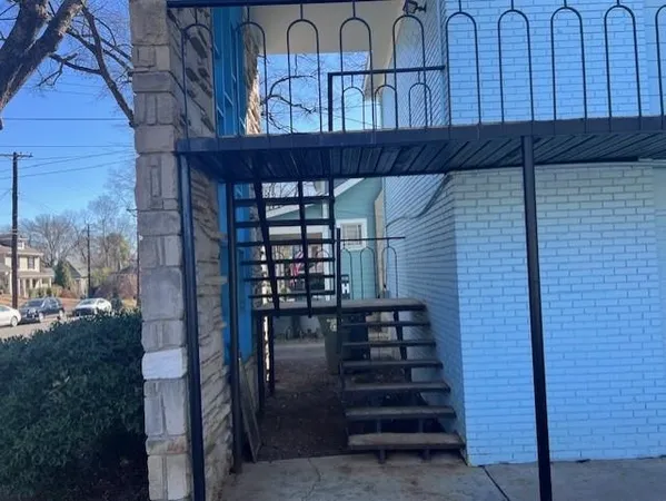 a view of a house with a small yard