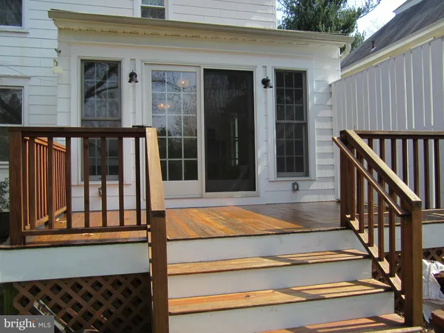 a green field with flowers and trees