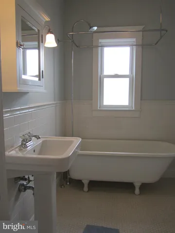 a bathroom with a sink mirror and vanity