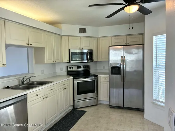 a kitchen with a sink stainless steel appliances and cabinets