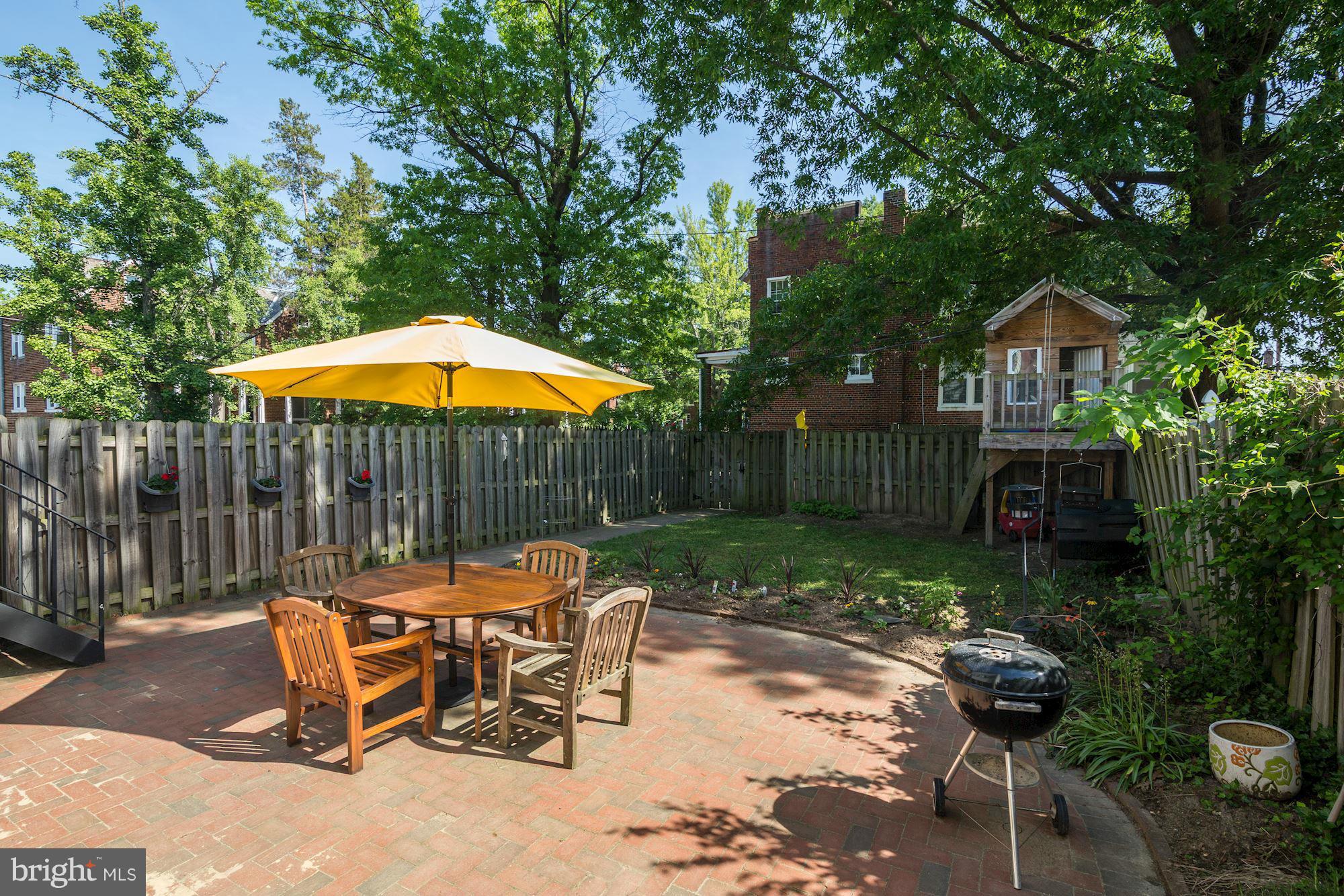 730 Rittenhouse Street Northwest Washington, DC 20011 - Photo 28 of 30 a patio with a table and chairs under an umbrella
