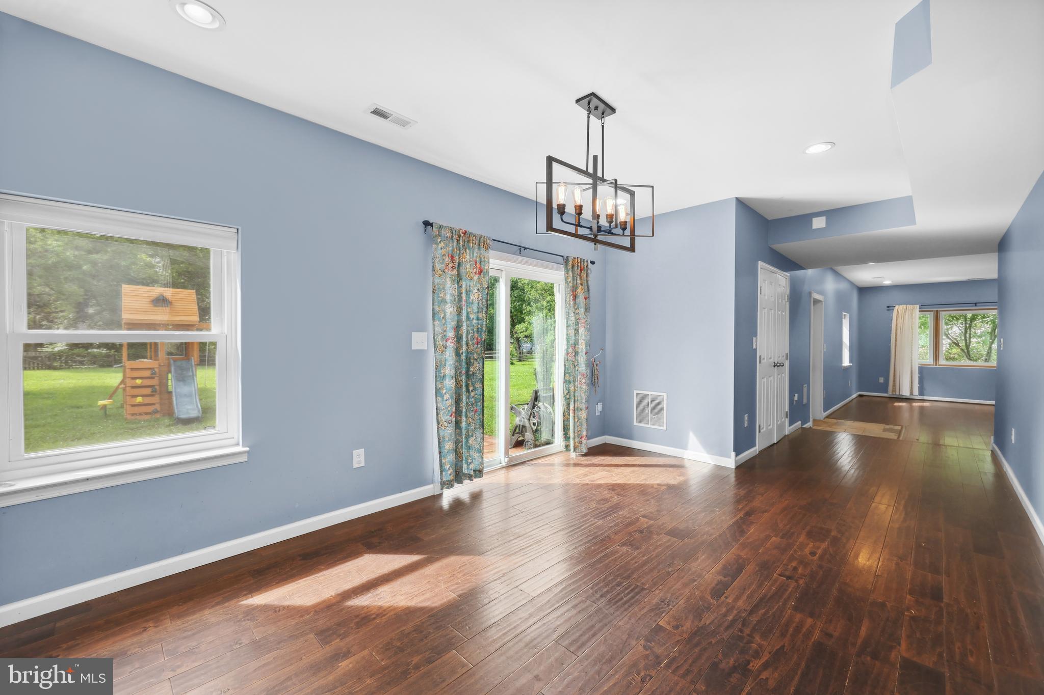 7103 Catlett Road Bealeton, VA 22712 - Photo 13 of 42 a view of an empty room with wooden floor and a window