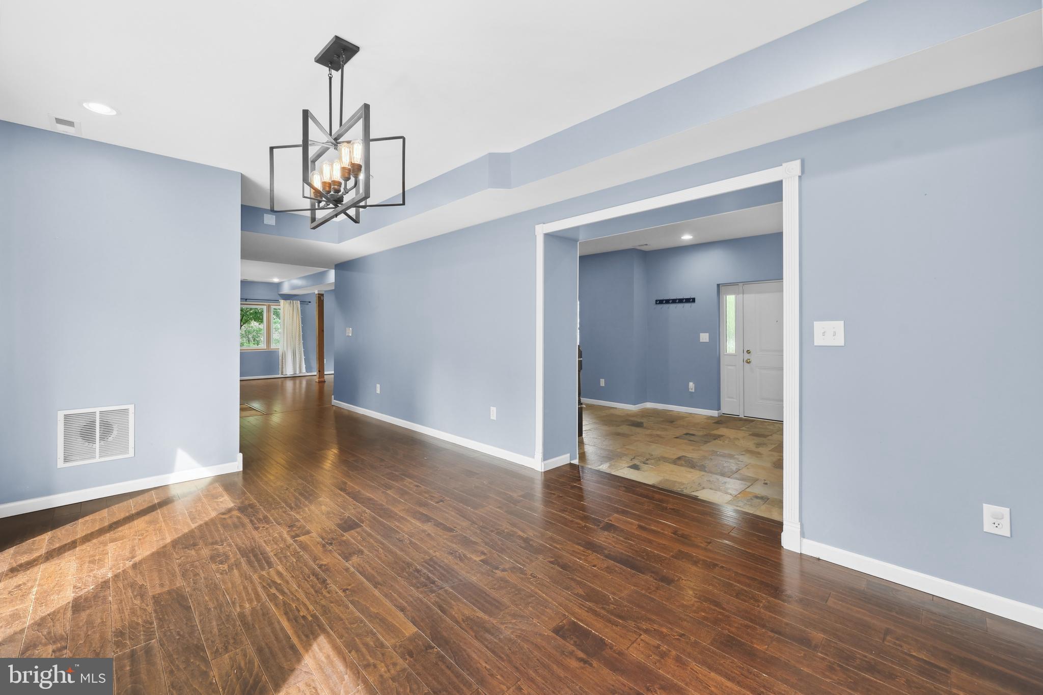 7103 Catlett Road Bealeton, VA 22712 - Photo 15 of 42 a view of a room with wooden floor and chandelier