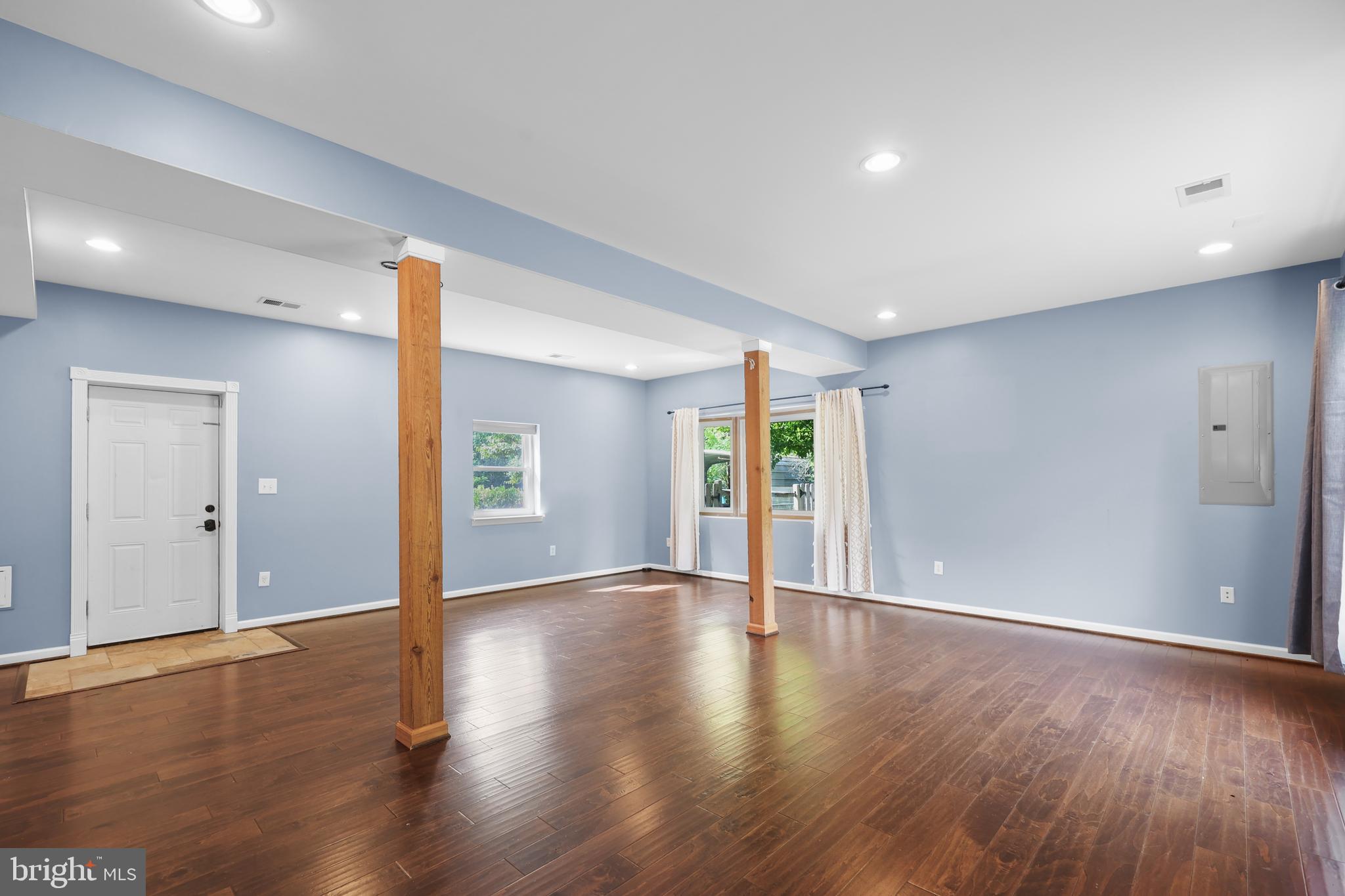 7103 Catlett Road Bealeton, VA 22712 - Photo 19 of 42 a view of an empty room with wooden floor and windows