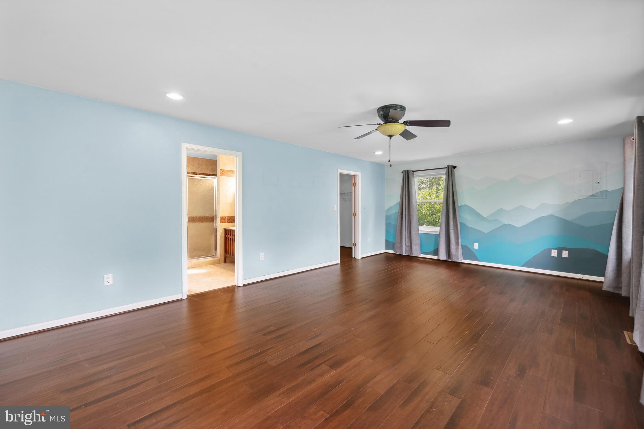 7103 Catlett Road Bealeton, VA 22712 - Photo 22 of 42 a view of an empty room with a window and wooden floor