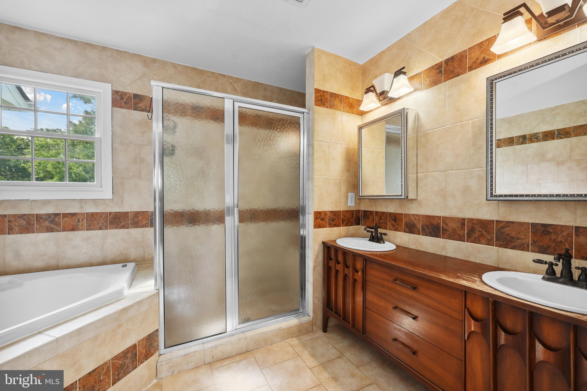 7103 Catlett Road Bealeton, VA 22712 - Photo 25 of 42 a bathroom with a double vanity sink mirror and shower