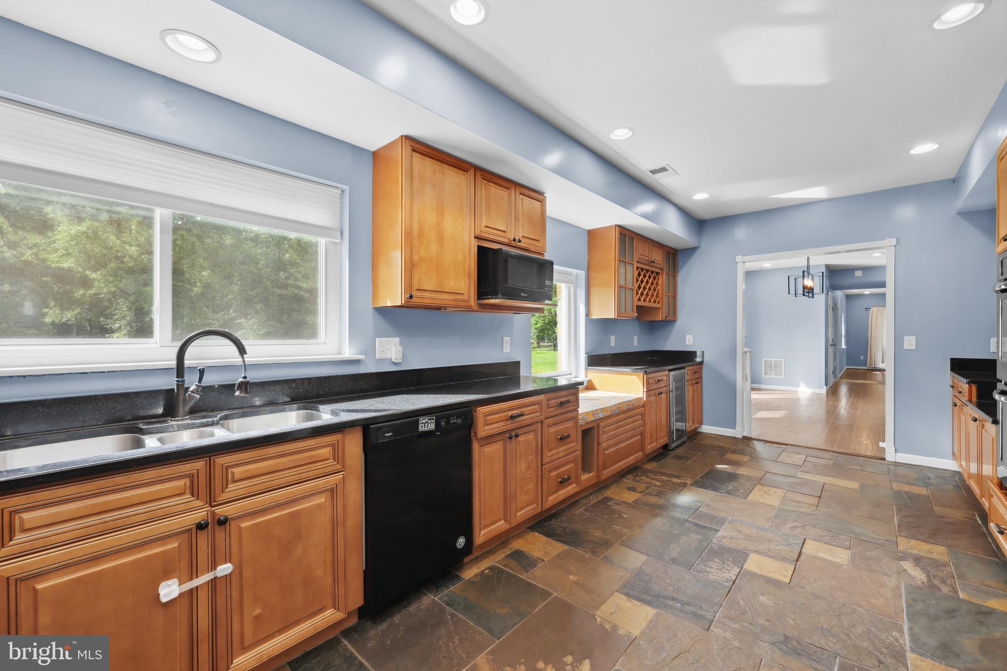 7103 Catlett Road Bealeton, VA 22712 - Photo 7 of 42 a kitchen with stainless steel appliances granite countertop a stove sink and cabinets