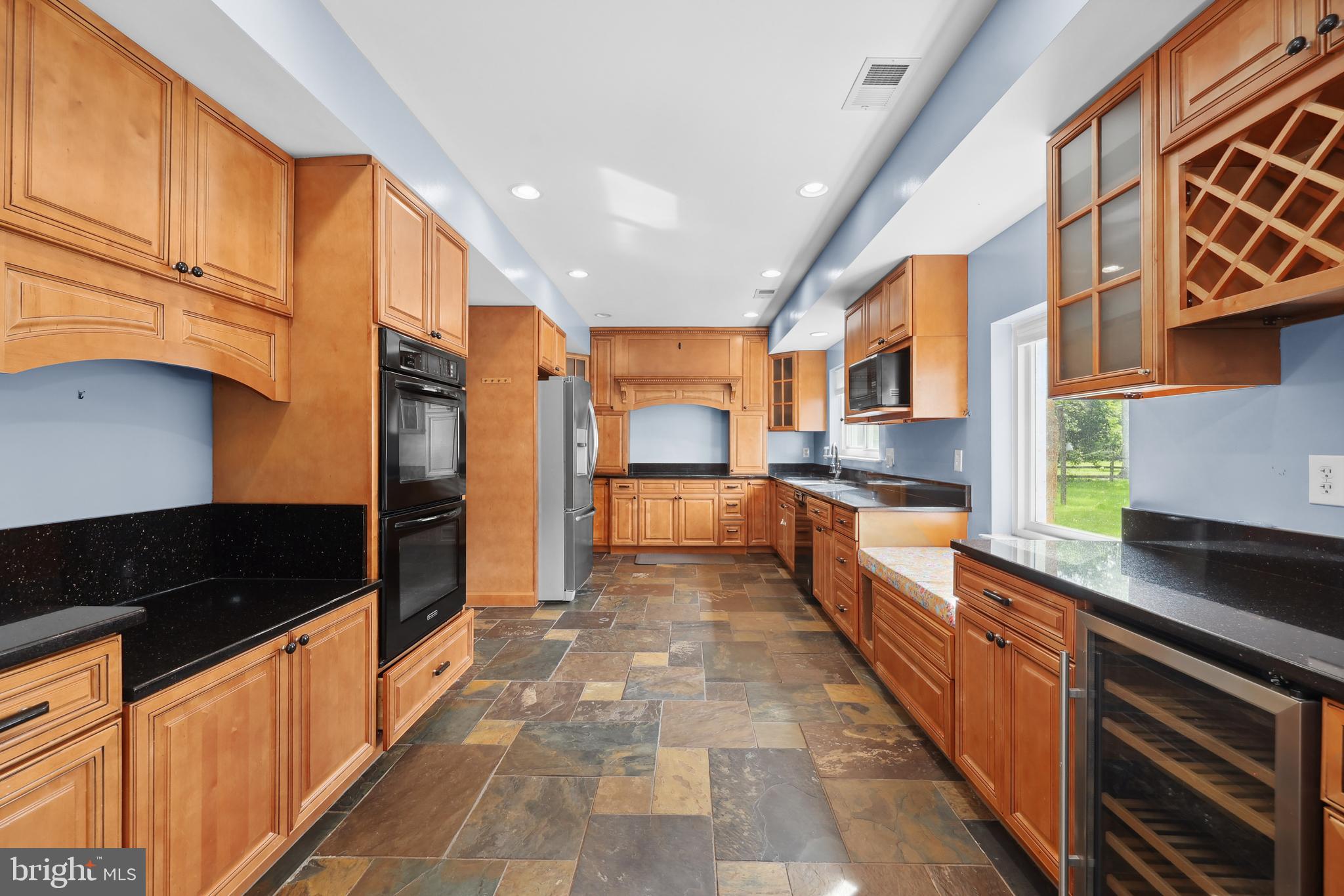 7103 Catlett Road Bealeton, VA 22712 - Photo 8 of 42 a large kitchen with stainless steel appliances granite countertop a large stove top oven a sink dishwasher and cabinets