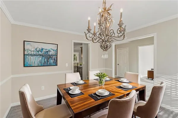a view of a dining room with furniture wooden floor and chandelier