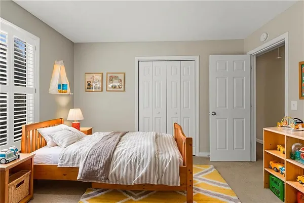 a bedroom with a bed and a window