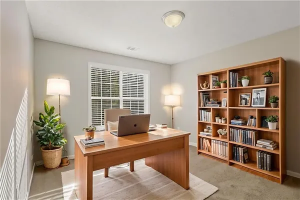 a workspace with furniture and a bookshelf