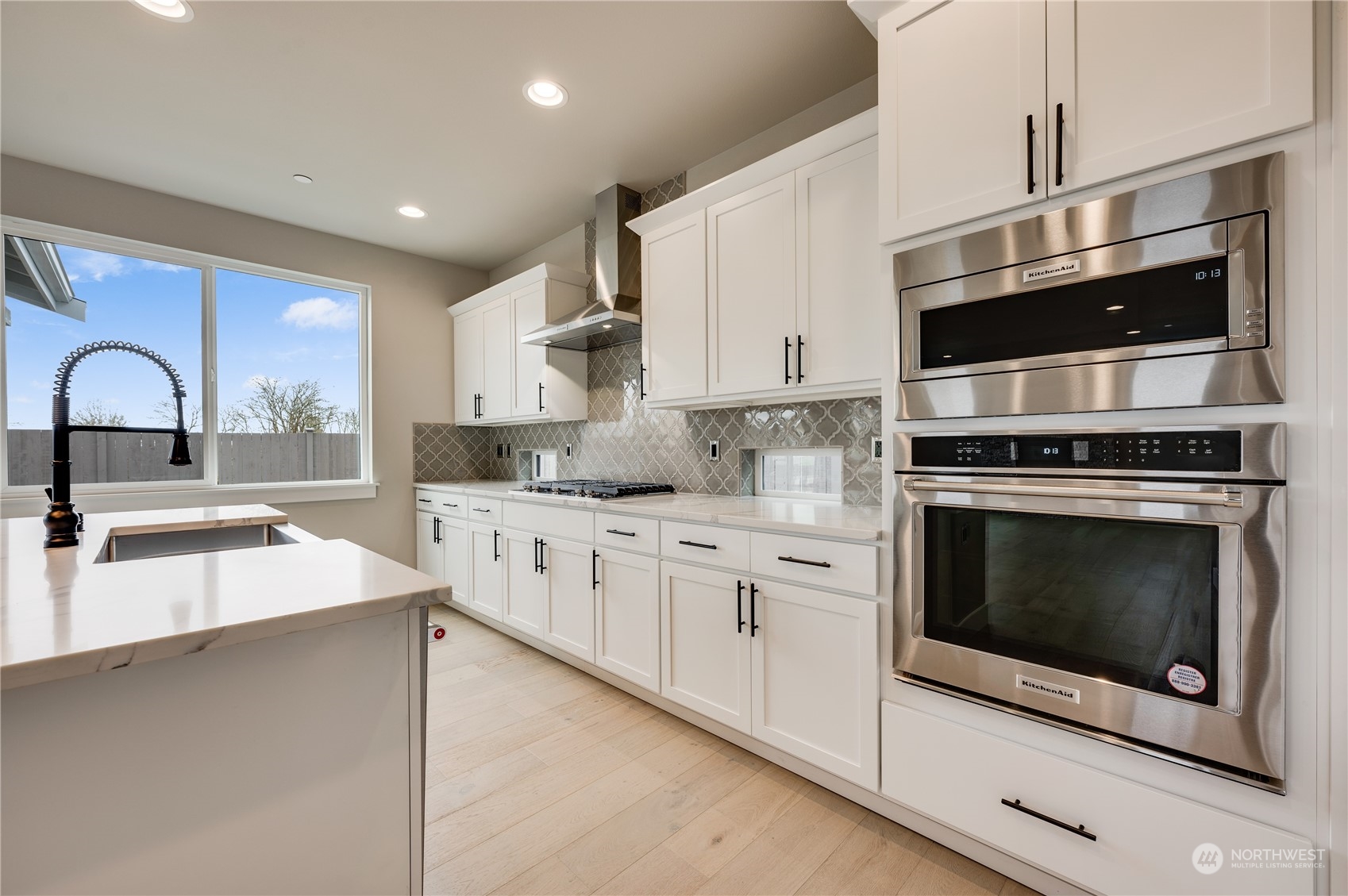 4403 242nd Place Southeast, Unit LOT16 Bothell, WA 98021 - Photo 12 of 27 a kitchen with stainless steel appliances a stove microwave and sink