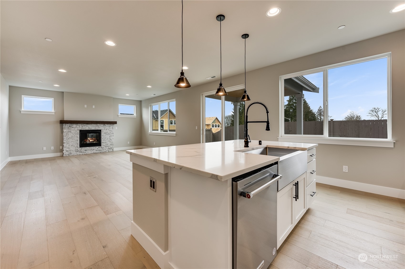 4403 242nd Place Southeast, Unit LOT16 Bothell, WA 98021 - Photo 14 of 27 a kitchen with kitchen island a sink a counter top space appliances and cabinets