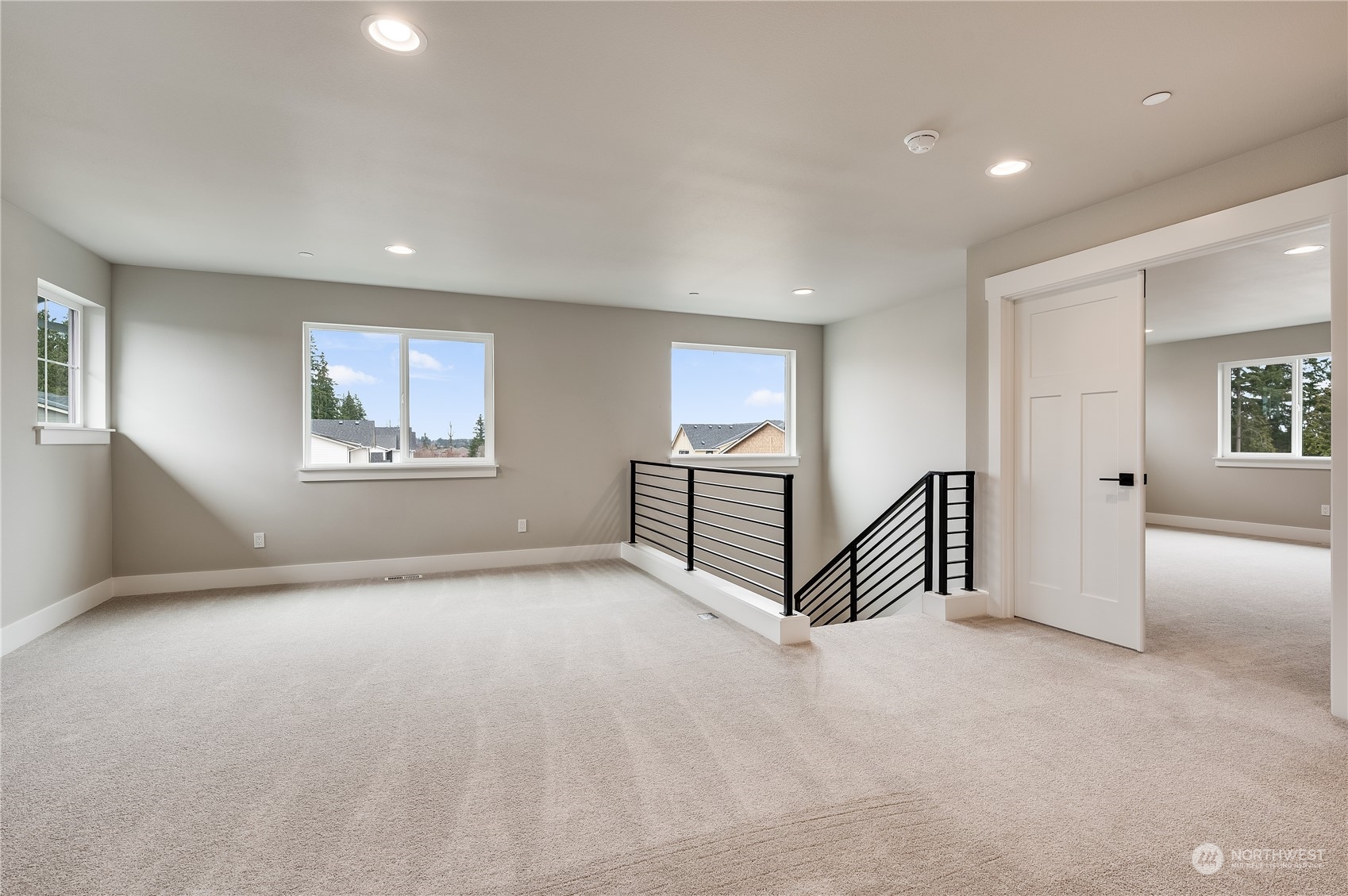 4403 242nd Place Southeast, Unit LOT16 Bothell, WA 98021 - Photo 17 of 27 an empty room with staircase and a ceiling fan