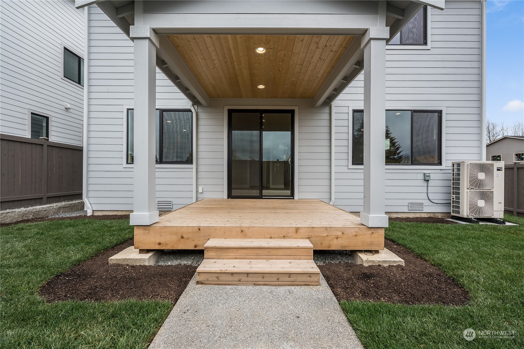 4403 242nd Place Southeast, Unit LOT16 Bothell, WA 98021 - Photo 23 of 27 a front view of a house with a garden