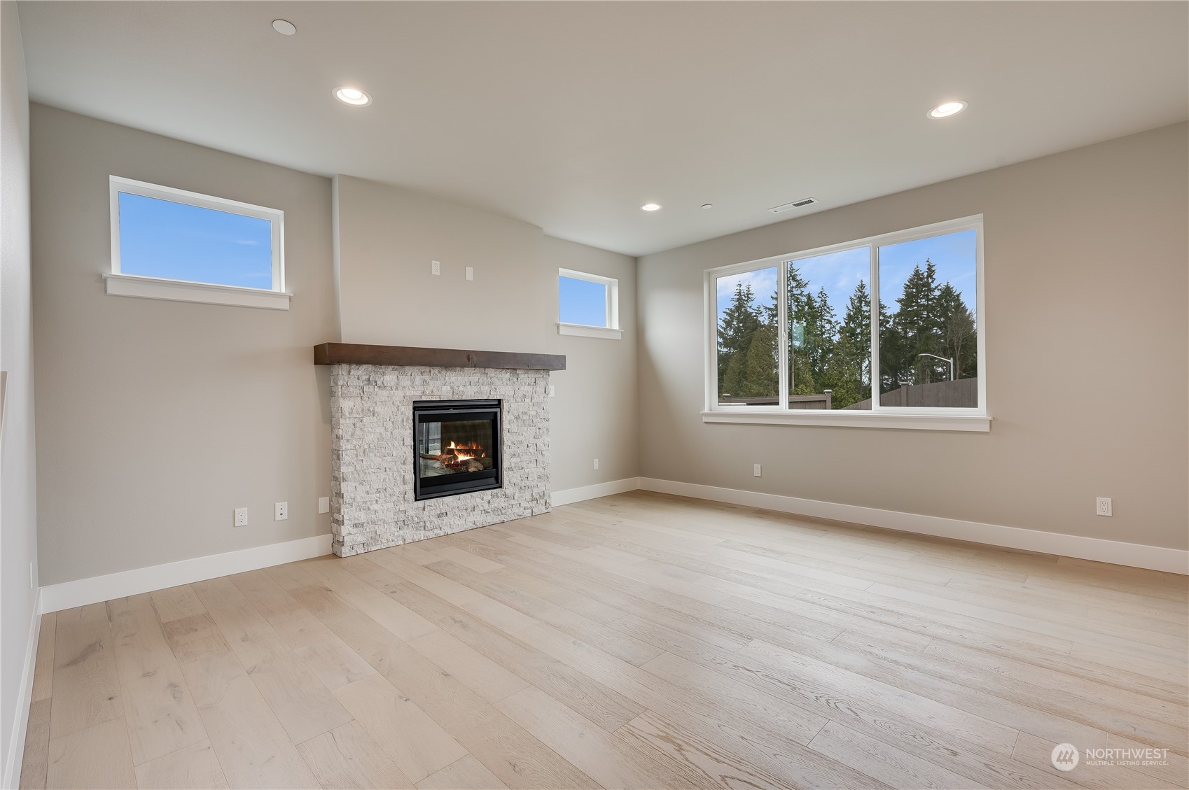 4403 242nd Place Southeast, Unit LOT16 Bothell, WA 98021 - Photo 7 of 27 a view of an empty room with a window and fireplace