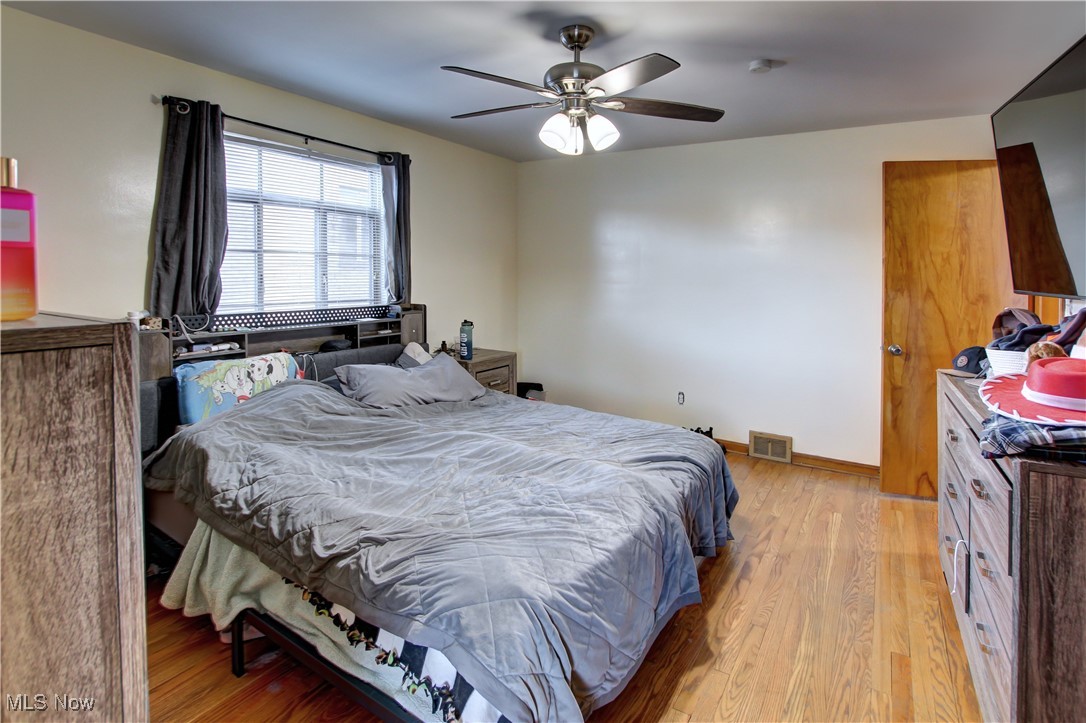 3422 Warren Road Cleveland, OH 44111 - Photo 22 of 32 Bedroom with light hardwood / wood-style floors and ceiling fan