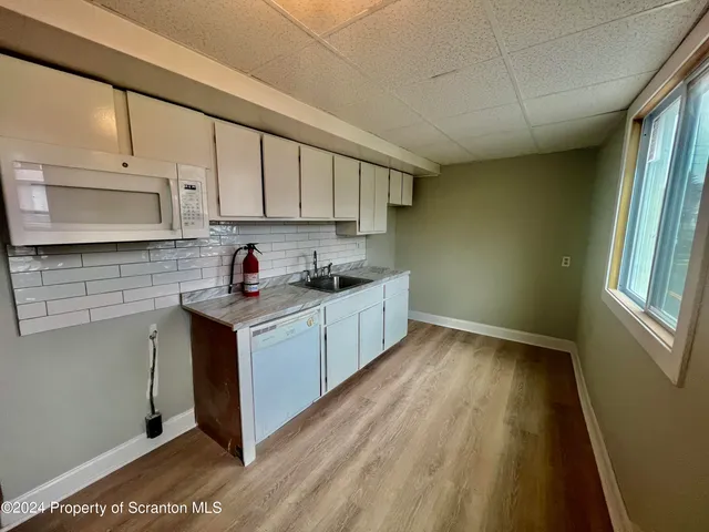 a kitchen with a sink a stove and cabinets