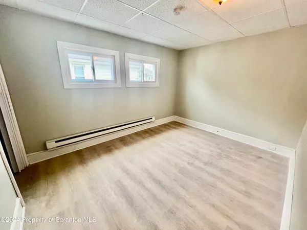 a view of a room with wooden floor