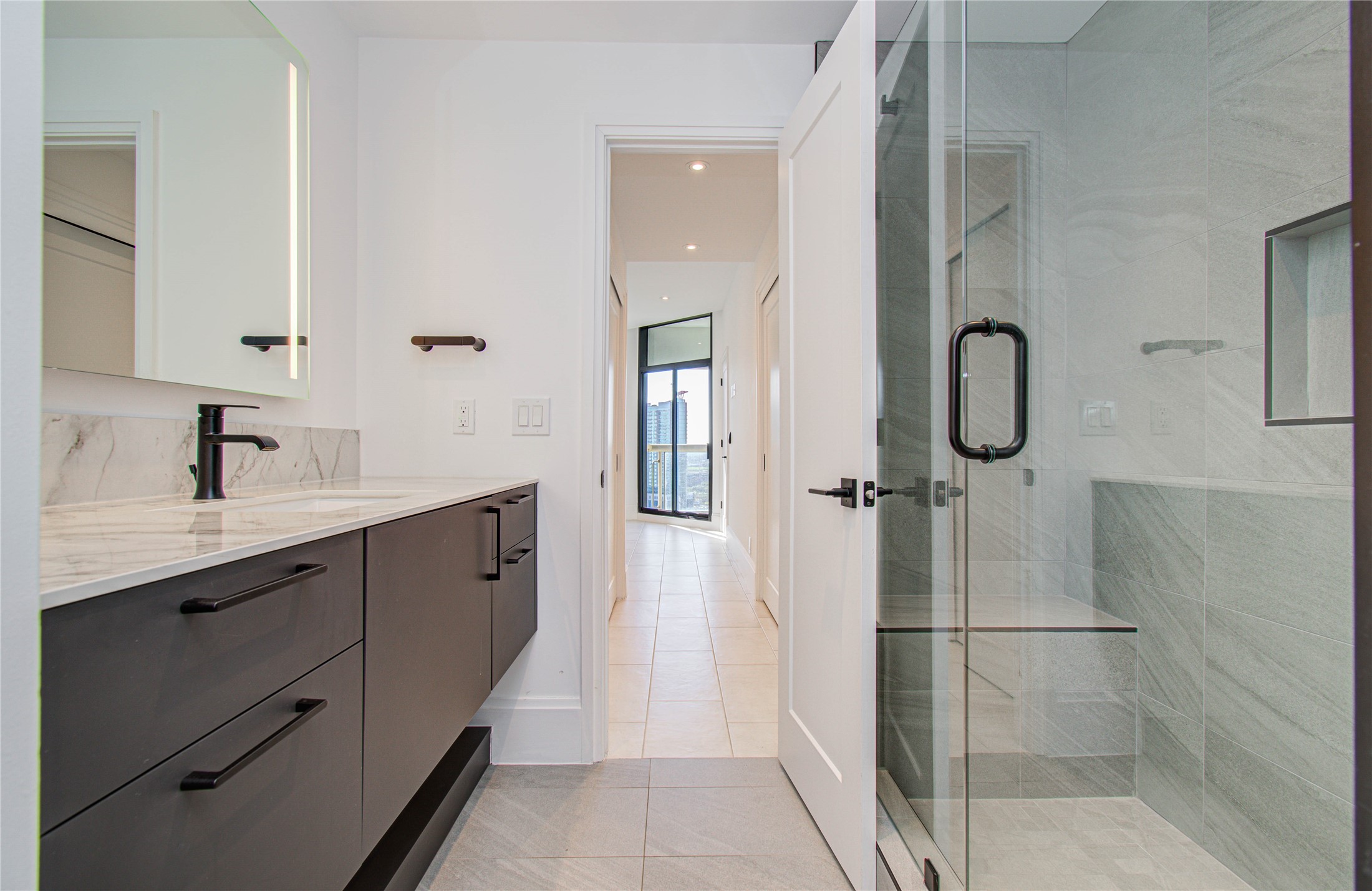 1701 Hermann Drive, Unit 20D Houston, TX 77004 - Photo 16 of 35 a spacious bathroom with a double vanity sink a mirror and shower