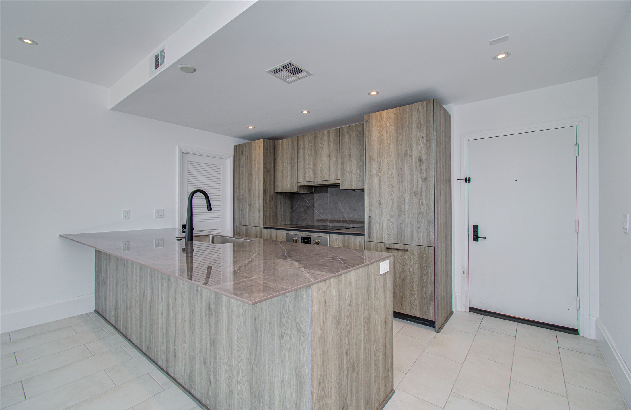 1701 Hermann Drive, Unit 20D Houston, TX 77004 - Photo 7 of 35 a kitchen with kitchen island sink stove and refrigerator