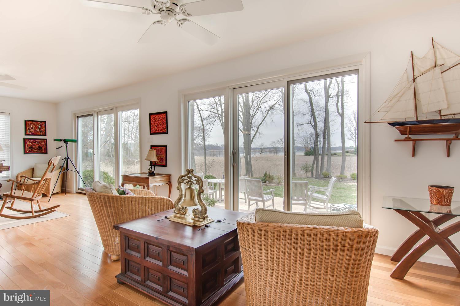 29030 Belchester Road Kennedyville, MD 21645 - Photo 15 of 30 a living room with furniture a flat screen tv and a large window