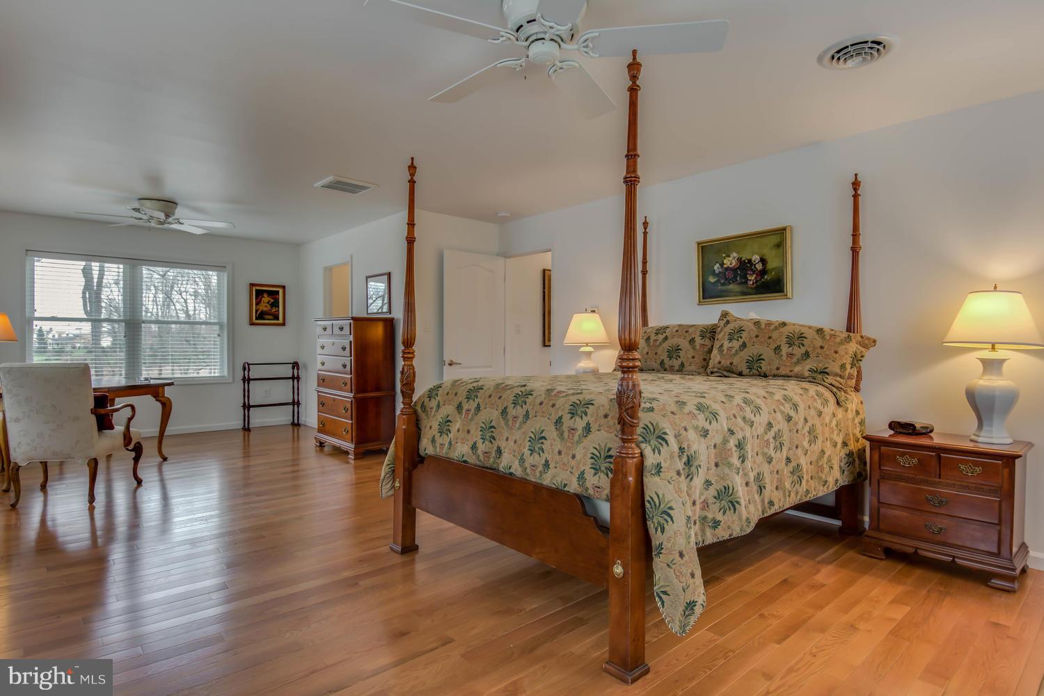 29030 Belchester Road Kennedyville, MD 21645 - Photo 20 of 30 a bedroom with a bed and a table in it