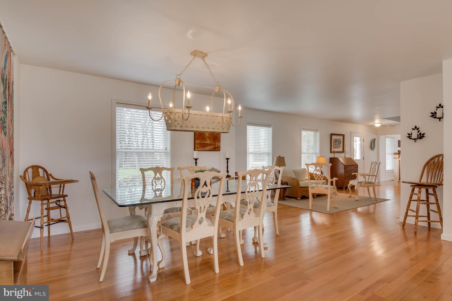 29030 Belchester Road Kennedyville, MD 21645 - Photo 9 of 30 a view of a dining room and livingroom with furniture wooden floor a chandelier