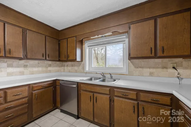 a kitchen with a sink cabinets and window